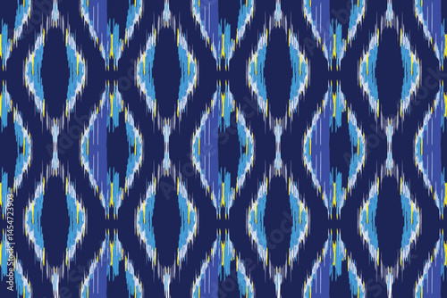 A seamless blue and white ikat pattern with a slightly blurred, diamond-like motif on a dark blue background.