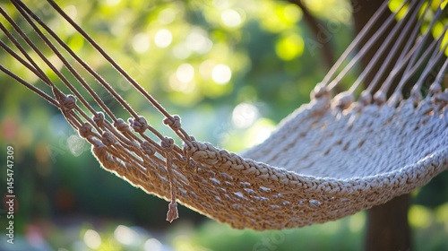 Hammock strings tangled artistically, soft bokeh in background showing garden trees and flowers
