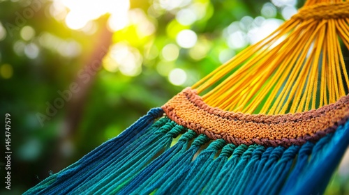 Obraz na płótnie Macro shot of colorful woven threads of a hammock, bright daylight with green jungle backdrop w salonie