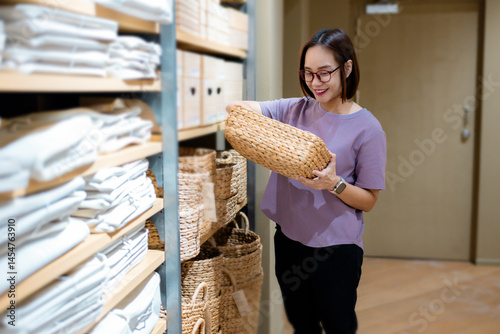 Customer holding wicker basket, shopping for home decoration in retail store