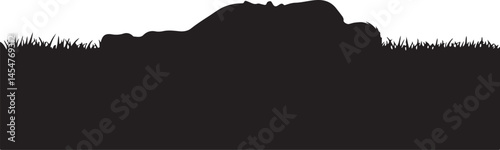 A vector silhouette of a homeless man sleeping on the street in a park with his backpack resting next to him in a vulnerable moment