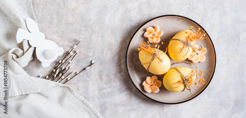 Obraz na płótnie Easter eggs decorated with dried flowers and marshmallows on a plate top view web banner w salonie