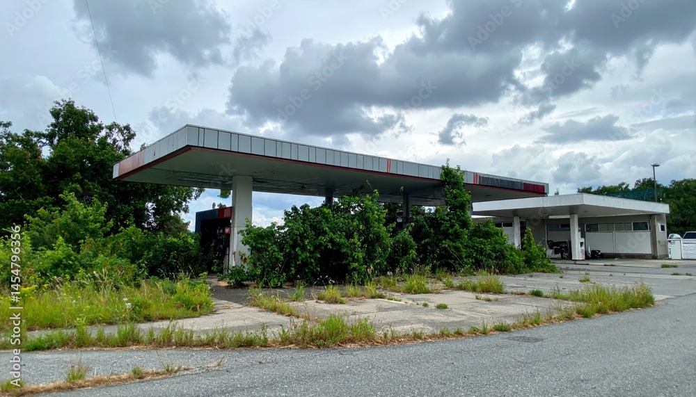 Abandoned Gas Station Surrounded by Overgrown Vegetation and Clouds Abandoned Gas Station Surrounded by Overgrown Vegetation and Clouds