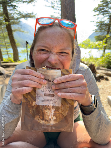 Woman Take A Bite Of Melted Trail Mix From Bag