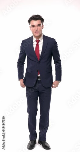 sexy businessman in navy blue suit folding arms, touching face, thinking, holding hands in pockets and smiling, adjusting hairstyle while moving on white background