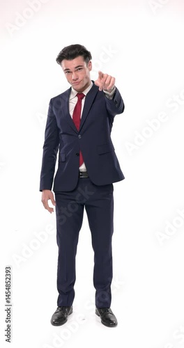 proud businessman wearing red tie with navy blue suit pointing finger forward and clapping while standing in front of white background