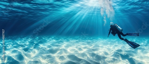Scuba diver swims underwater, exploring depths with tranquility, illuminated by sunlight, enjoying underwater activity.