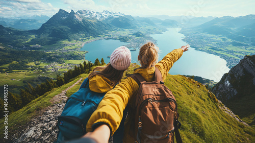 Friends taking a scenic selfie with a breathtaking mountain view.