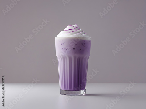 ice ube latte in a tall glass, creamy top
