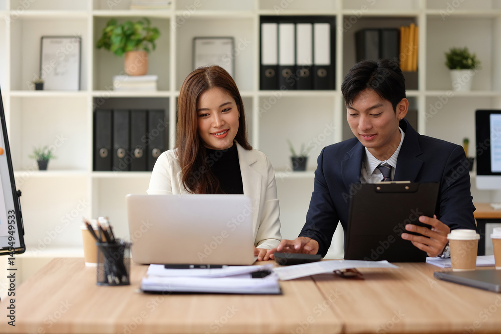 Male and female coworkers discuss the next meeting in the office. Male and female coworkers discuss the next meeting in the office.