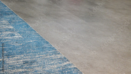 Contrasting Textures: Blue Carpet Meets Smooth Concrete Surface Interior design