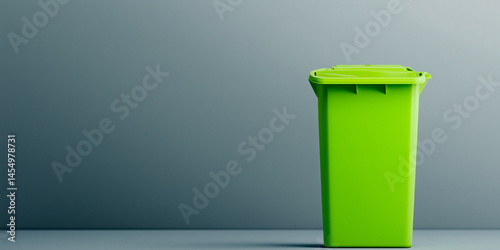 Obraz na płótnie Tall green plastic waste bin against a gray background w salonie