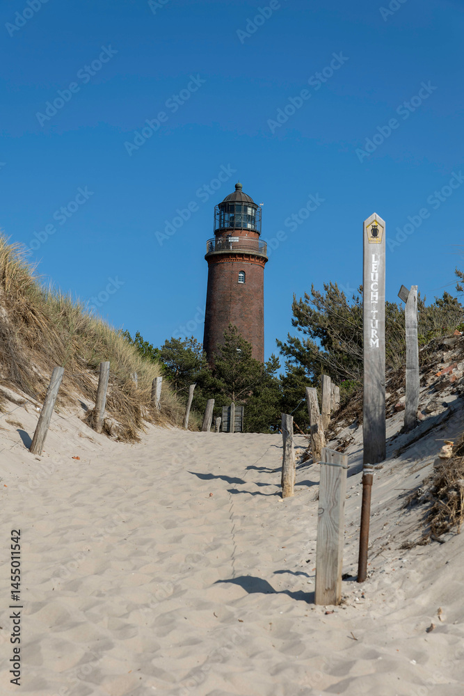 Obraz premium Explore the scenic paths leading to Darßer Ort Lighthouse near the German Baltic Sea shore