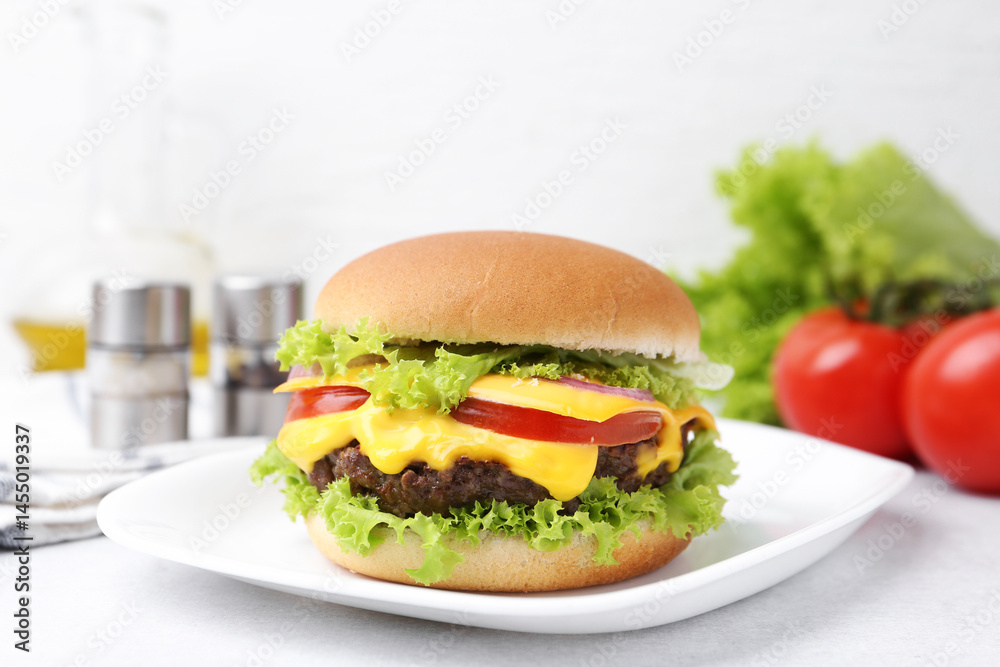 Tasty cheeseburger with lettuce and tomatoes on white table, closeup Tasty cheeseburger with lettuce and tomatoes on white table, closeup