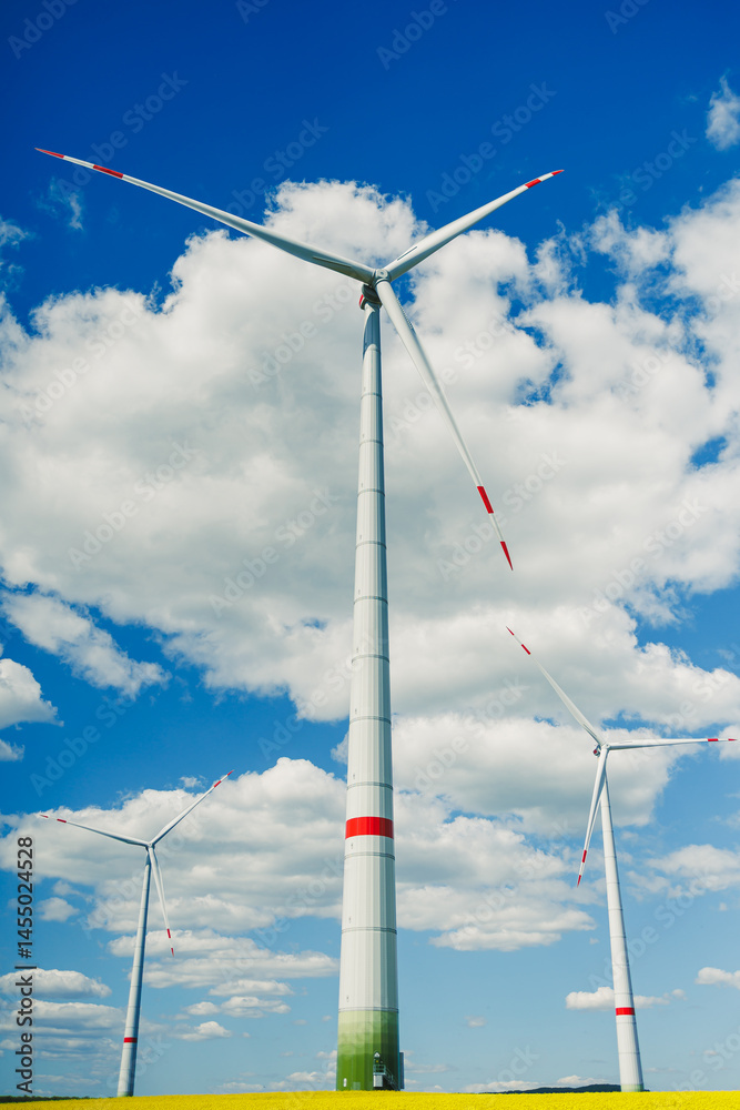 Windmill for generating energy against a blue sky. Windmill in a rural area in Europe.