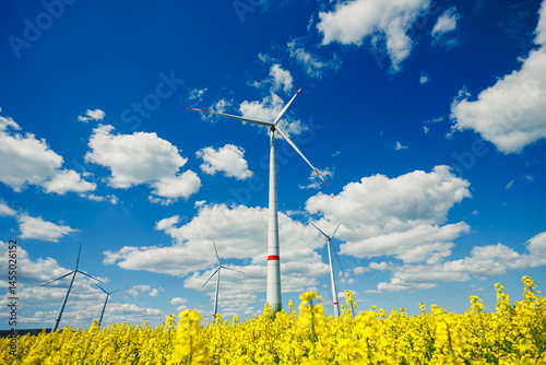 Obraz na płótnie Wind turbine on sky background and grass with farmland for eco friendly environment or alternative energy in rural area. Energy with farm for sustainable ecosystem w salonie