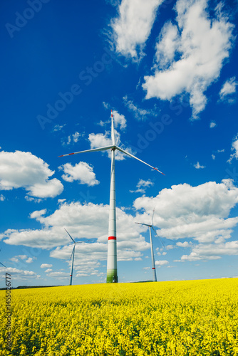 Obraz na płótnie Wind turbine on sky background and grass with farmland for eco friendly environment or alternative energy in rural area. Energy with farm for sustainable ecosystem w salonie