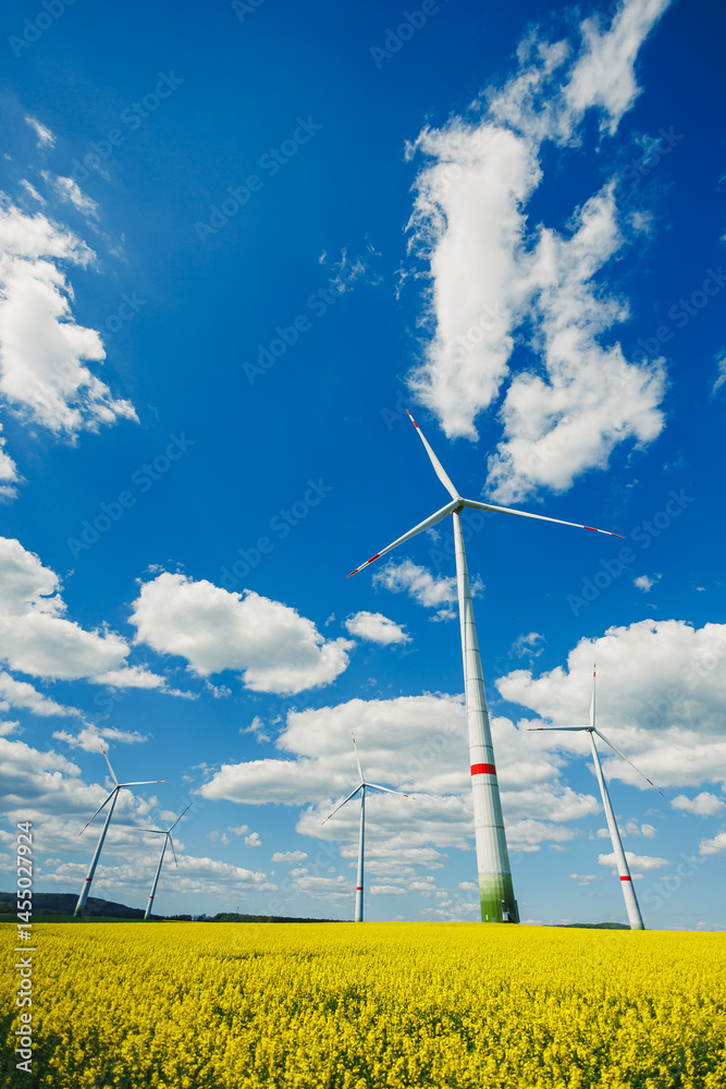 Wind turbine on sky background and grass with farmland for eco friendly environment or alternative energy in rural area. Energy with farm for sustainable ecosystem