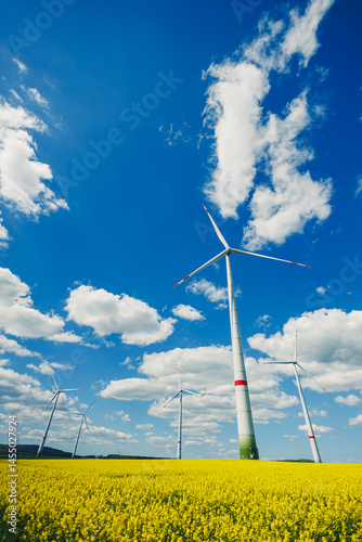 Obraz na płótnie Wind turbine on sky background and grass with farmland for eco friendly environment or alternative energy in rural area. Energy with farm for sustainable ecosystem w salonie