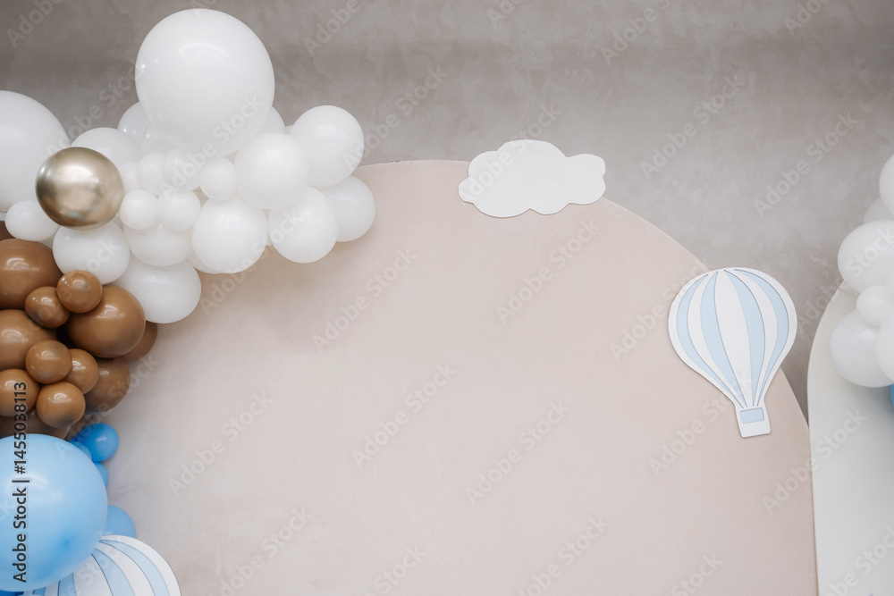Large photo zone for a children's birthday party with helium white balloons. Bright celebration of a children's birthday party with blue balloons.