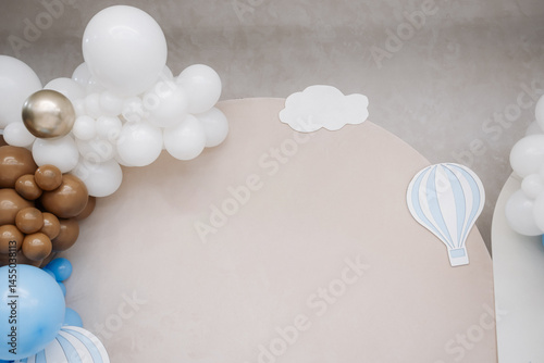 Large photo zone for a children's birthday party with helium white balloons. Bright celebration of a children's birthday party with blue balloons.