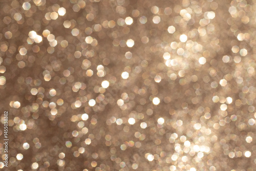 Golden bokeh background with shimmering light sparkles and abstract circular patterns