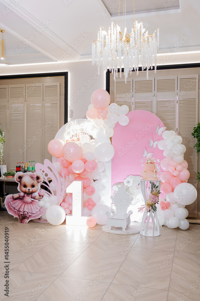 Photo zone for celebrating a child's birthday decorated with helium balloons. Children's photo zone for the first birthday with balloons and a cake.