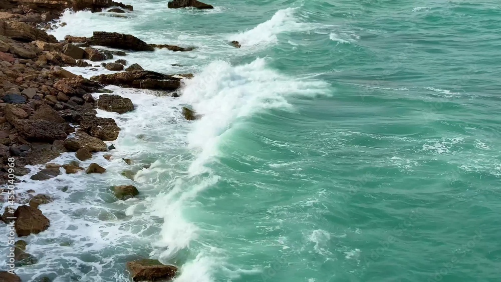 Fototapeta premium Experience Coastal Waves crashing on Rocky Shoreline, showcasing natures beauty and fresh air