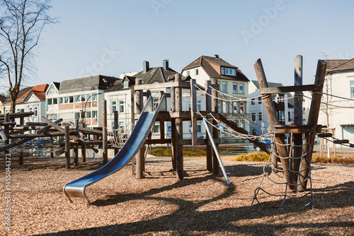 Obraz na płótnie Urban playground with a slide in the open air. Wooden playground. w salonie