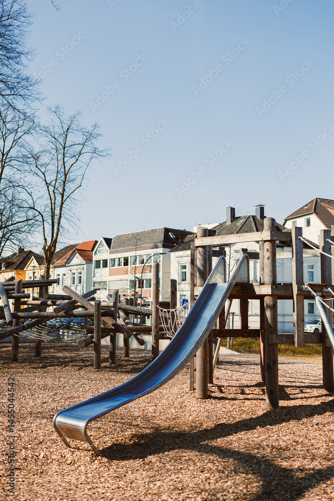 Urban playground with a slide in the open air. Wooden playground.