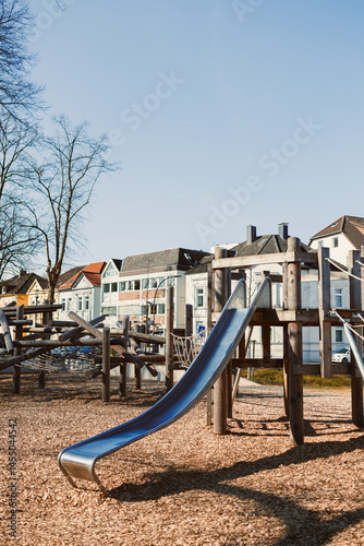 Obraz na płótnie Urban playground with a slide in the open air. Wooden playground. w salonie