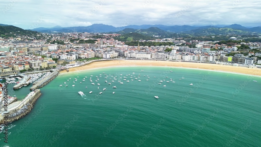 Fototapeta premium An Aerial View of a Beautiful Beach featuring Boats and a Cityscape in the Background