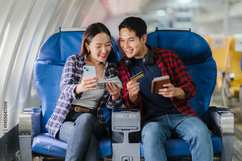 Couple Planning Vacation on Airplane