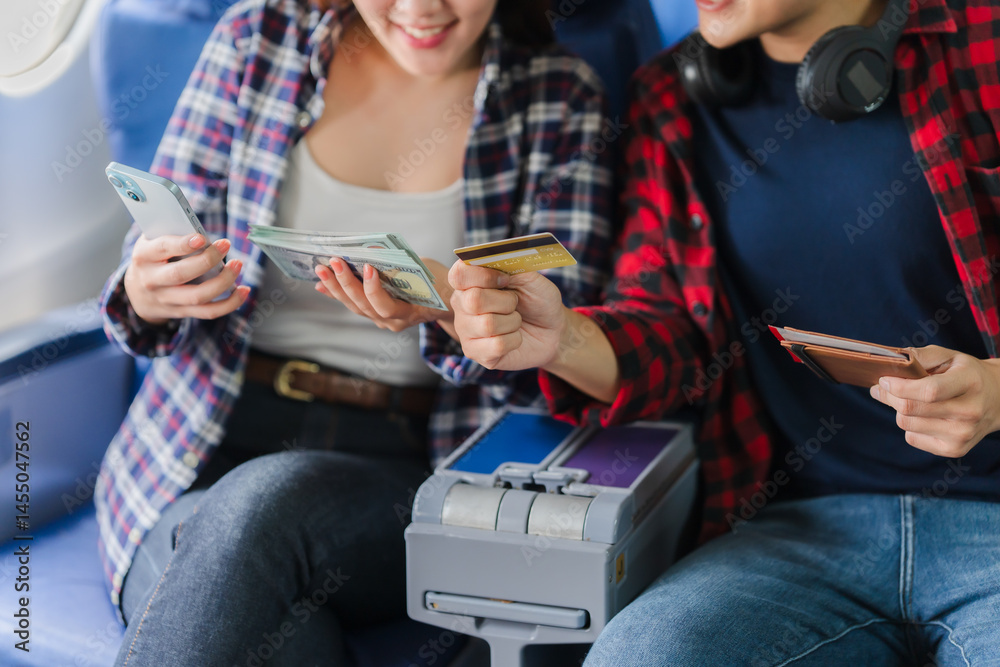 Couple Planning Travel Expenses on Airplane