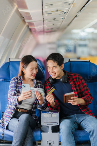 Couple Planning Travel on Airplane