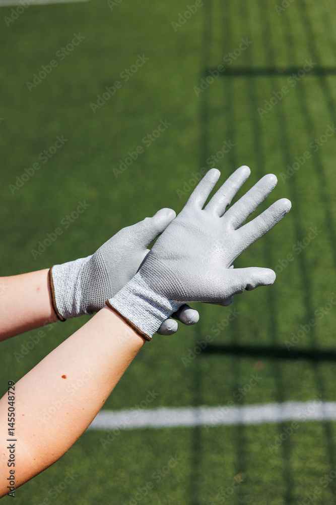 Rough gloves on men's hands for a construction worker. Construction gloves. Durable gloves for dirty work. Garden gloves. Rubberized construction gloves.