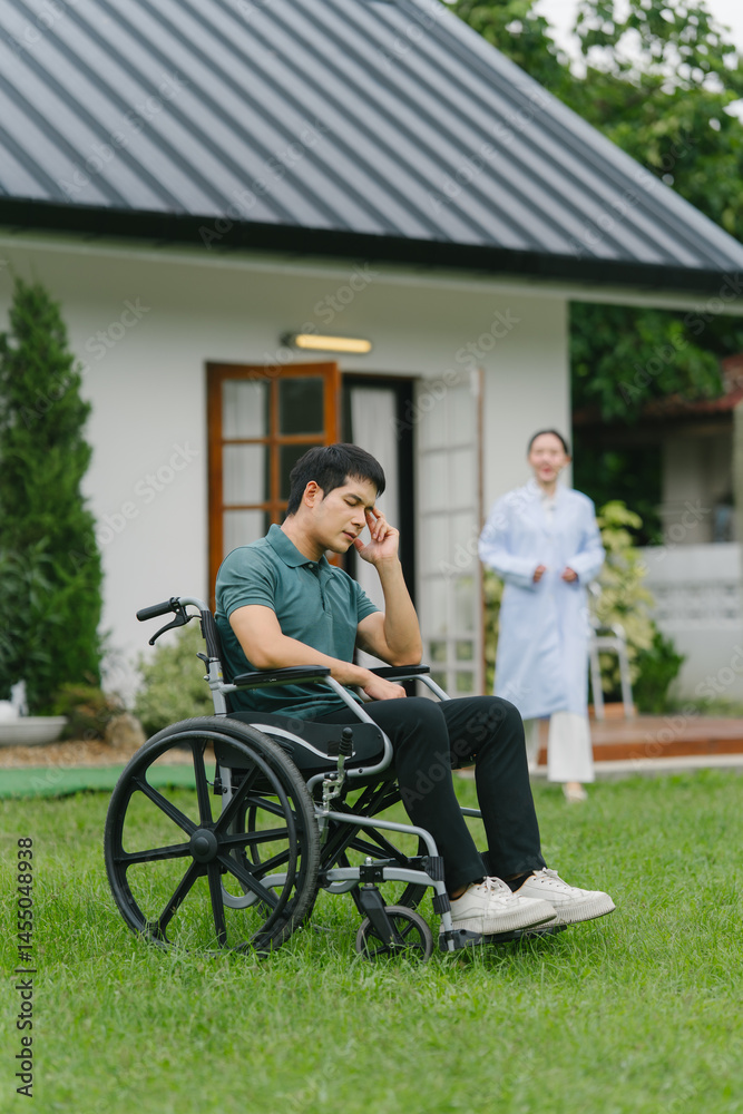 Depressed Man in Wheelchair with Caregiver Depressed Man in Wheelchair with Caregiver