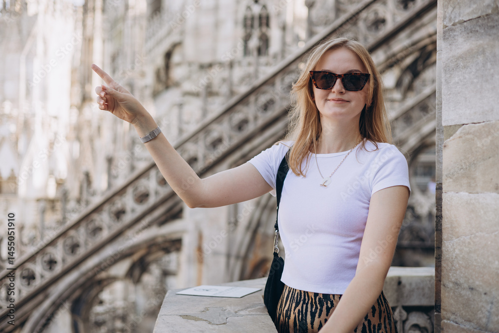 Female traveler standing on the rooftop of Duomo cathedral in Milan. Having great vacations in Milan