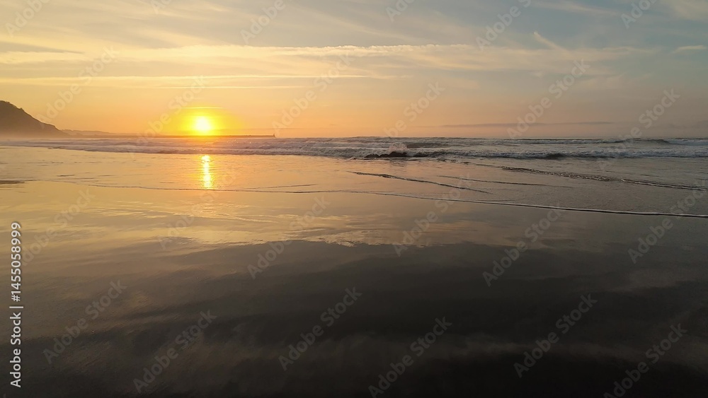 Fototapeta premium Experience the serene beauty of a sunset over peaceful beach waves, a perfect escape