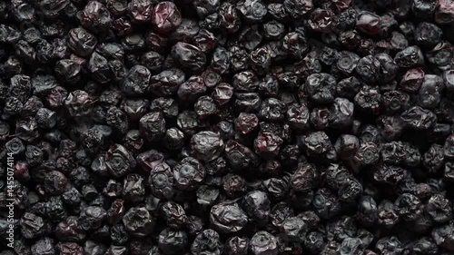 Dried wild blueberries background, rotates, close up, top view, macro. Pile of dry blueberry from dehydrator. Concept of preserving vitamins for winter, healthy eating