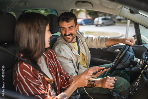 adult woman girlfriend using mobile phone while drive with boyfriend