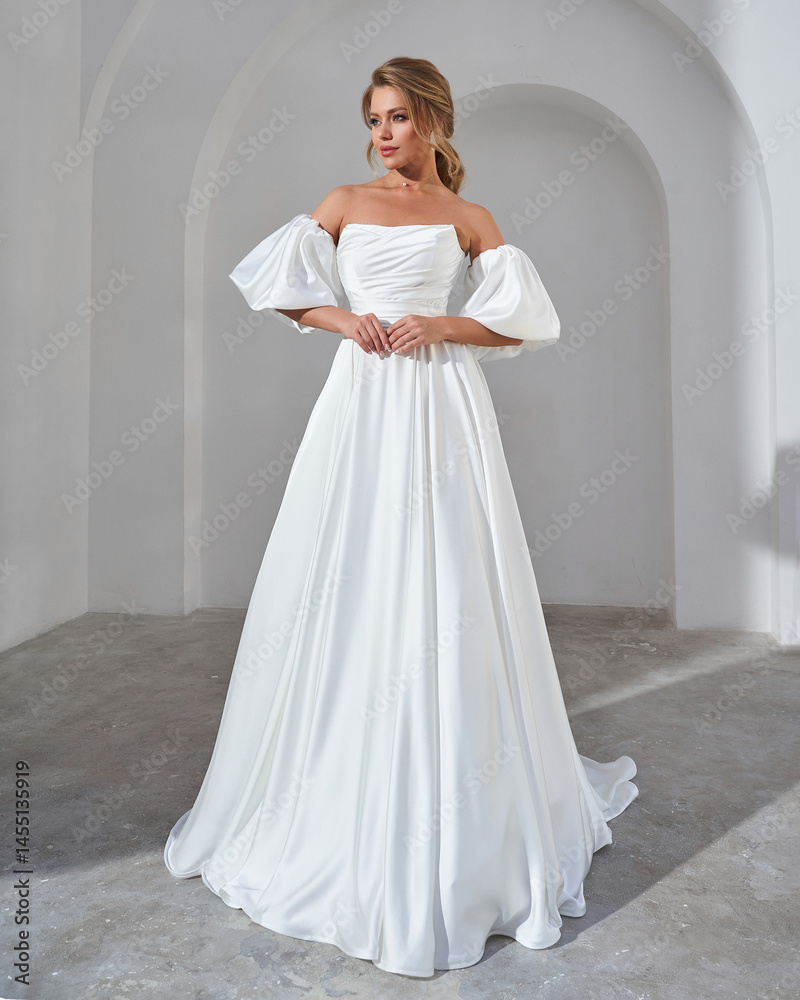 Fototapeta premium Elegant Bride in Off-Shoulder White Wedding Dress