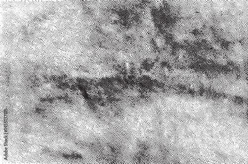 A dense textured landscape reveals rocky formations beneath a cloudy sky.