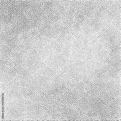 A densely patterned surface exhibits a multitude of tiny evenly spaced dark dots against a clean white background.