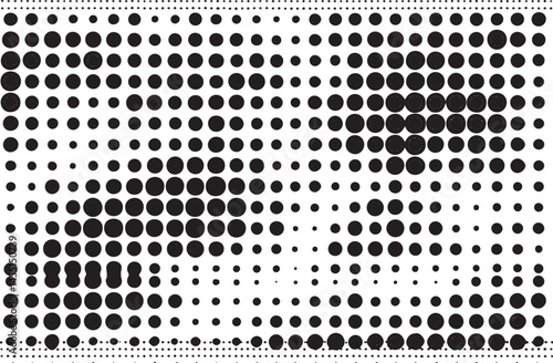A densely packed field of white and black circles gradually transitions from dark to light.