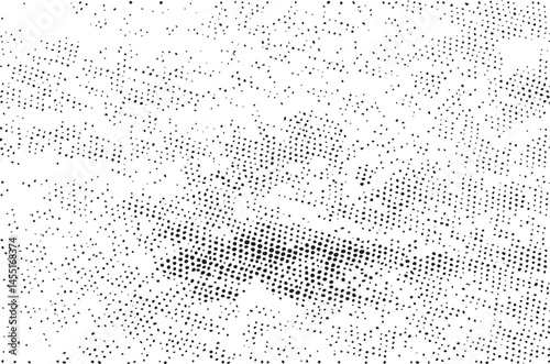 A dense textured field of scattered dark dots dominates a bright white background.