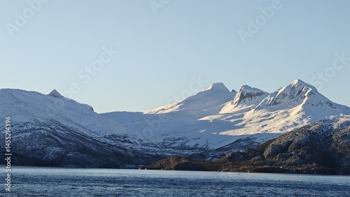 The mountains are covered in snow and the sky is clear