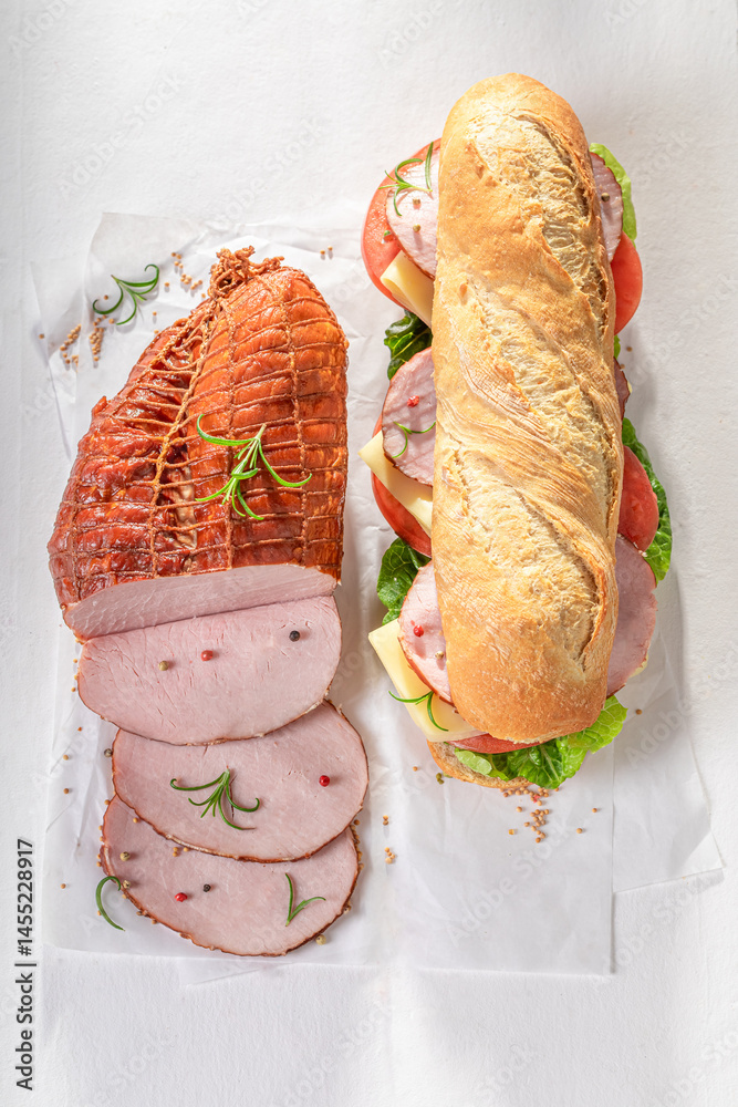 Tasty and fresh sandwich with ham, tomato and lettuce.