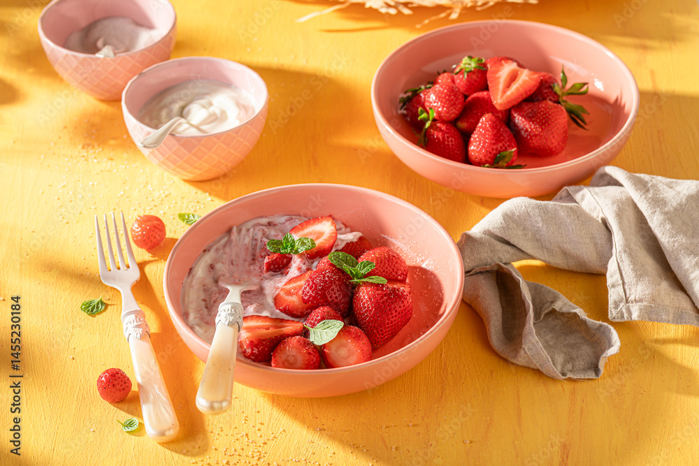 Tasty and creamy strawberries with sugar and yogurt.