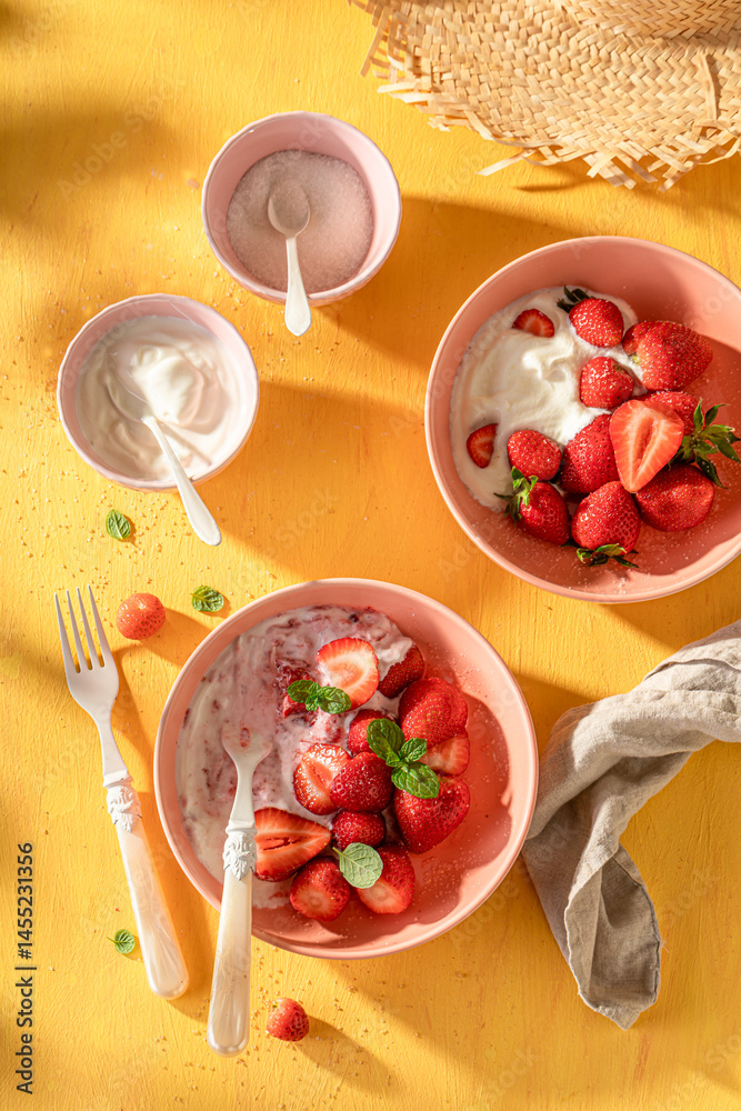 Fresh and sweet strawberries with sugar and yogurt.